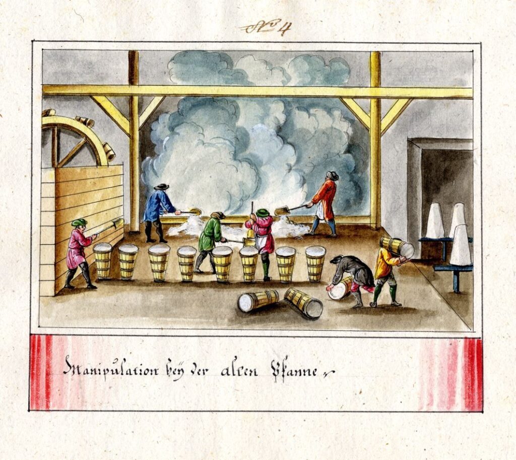 dampfende Sudpfanne mit Salzkufen im Vordergrund